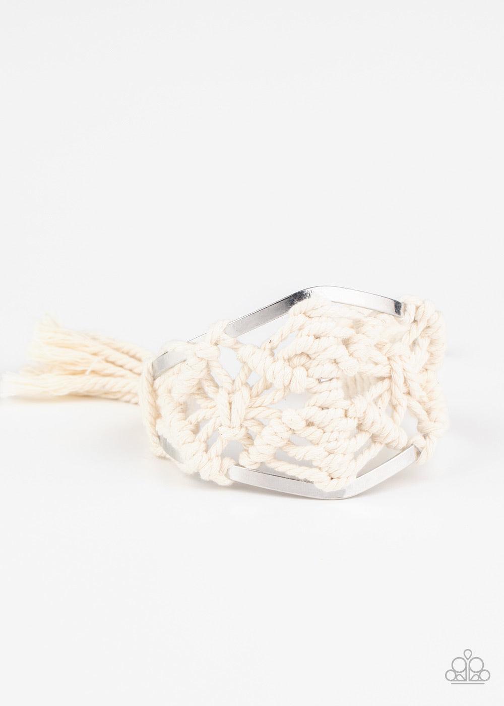 Paparazzi Accessories Macrame Mode - White White cording decoratively knots and weaves around an airy silver cuff for a macramé inspired look. Knotted around the ends, white tassels flair out from bottoms of the cuff for a wanderlust finish.Sold as one in