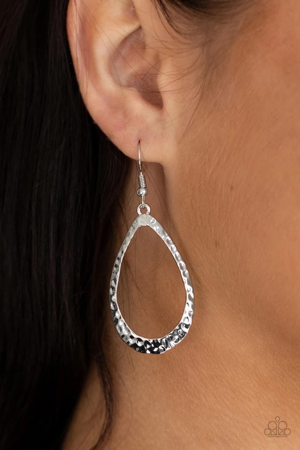 Paparazzi Accessories BEVEL-headed Brilliance - Silver Hammered in blinding shimmer, a beveled silver teardrop frame swings from the ear for a classic look. Earring attaches to a standard fishhook fitting.Sold as one pair of earrings. Jewelry
