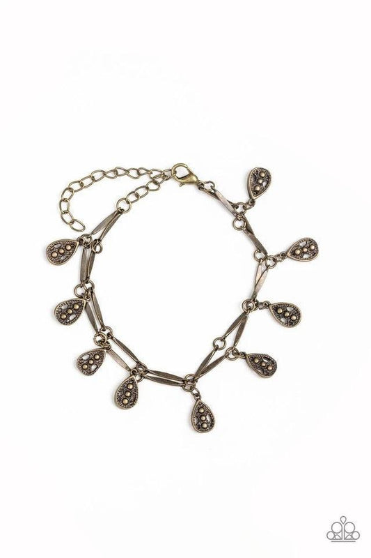 Paparazzi Accessories Gypsy Glee - Brass Glistening brass rods and ornate teardrops link around the wrist in two rows, creating a playful fringe. Features an adjustable clasp closure. Jewelry