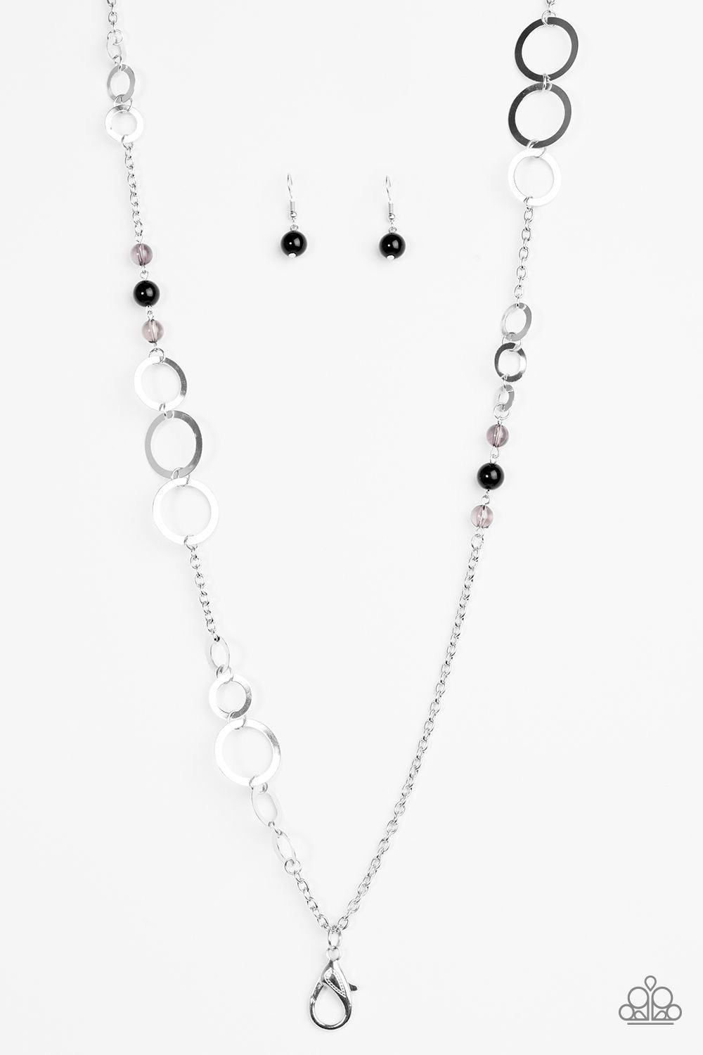 Paparazzi Accessories The GLOW-est of The Glow - Black *Lanyard Shimmery silver hoops give way to sections of glassy and polished black beading for a seasonal look. A lobster clasp hangs from the bottom of the design to allow a name badge or other item to