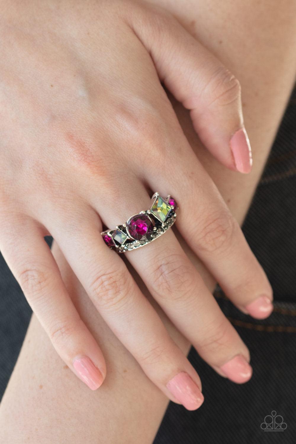 Paparazzi Accessories Champion Couture ~Pink A collection of round and square pink and oil spill rhinestones coalesce atop a silver band encrusted in dainty hematite rhinestones for a dramatic look. Features a dainty stretchy band for a flexible fit.