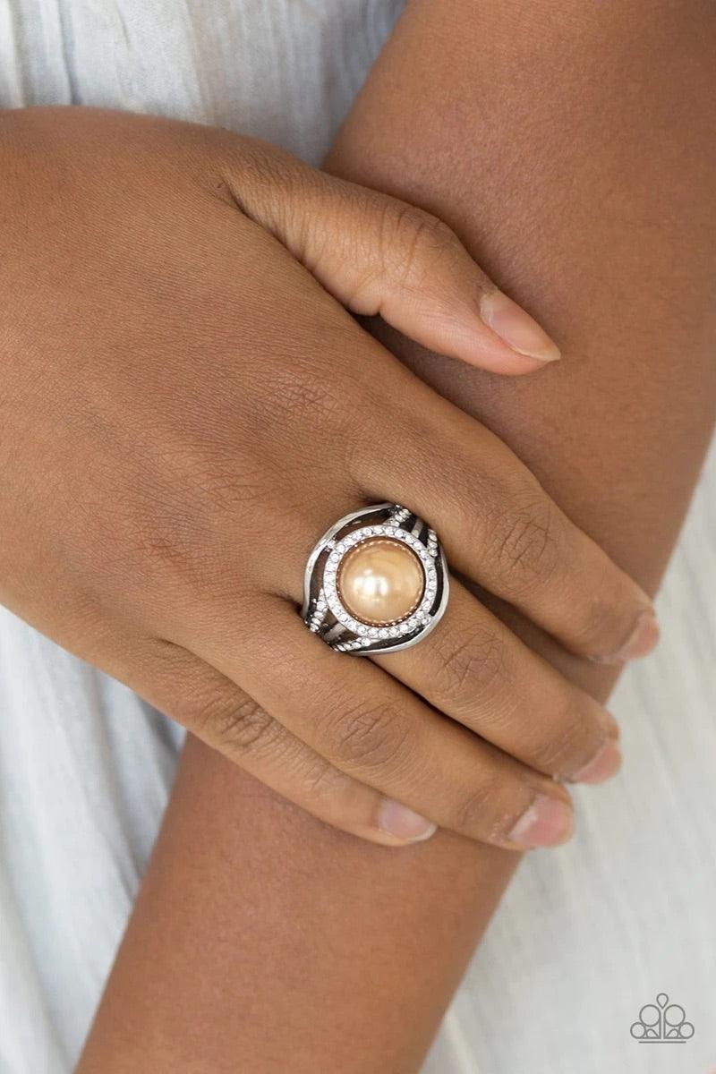 Paparazzi Accessories Pampered In Pearls ~Brown Shiny silver bands and white rhinestone encrusted bands flare from a brown pearl drop center for a glamorous look. Features a stretchy band for a flexible fit. Sold as one individual ring. Jewelry