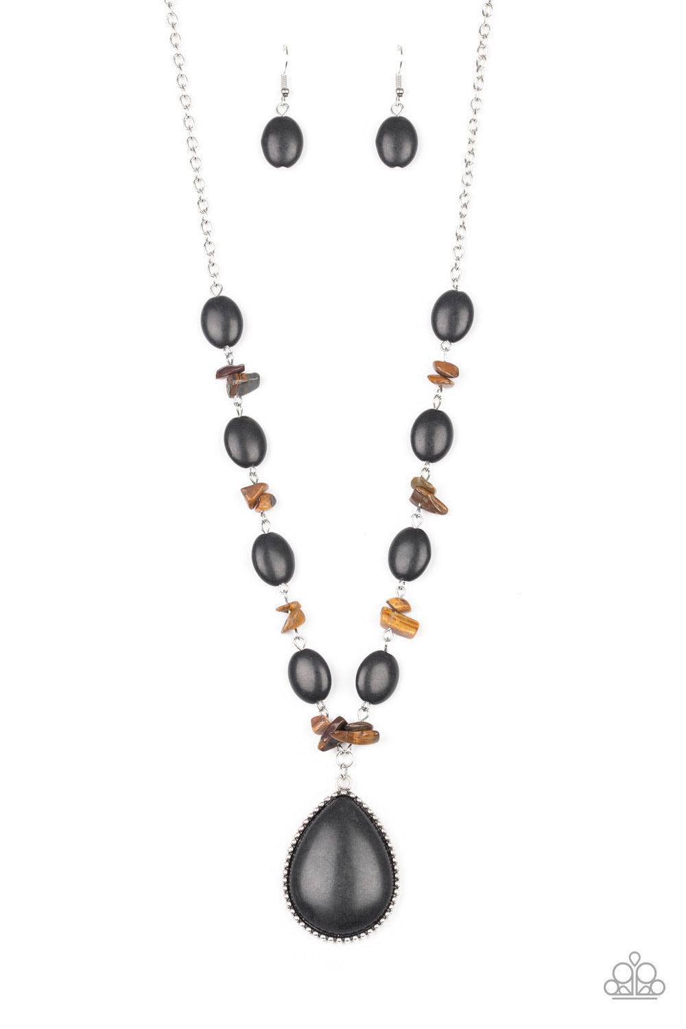 Paparazzi Accessories Desert Diva - Black Earthy black stones join bits of tiger's eye rock along a silver chain below the collar. Featuring a studded silver frame, an oversized black teardrop stone pendant swings from the center for a statement-making fi