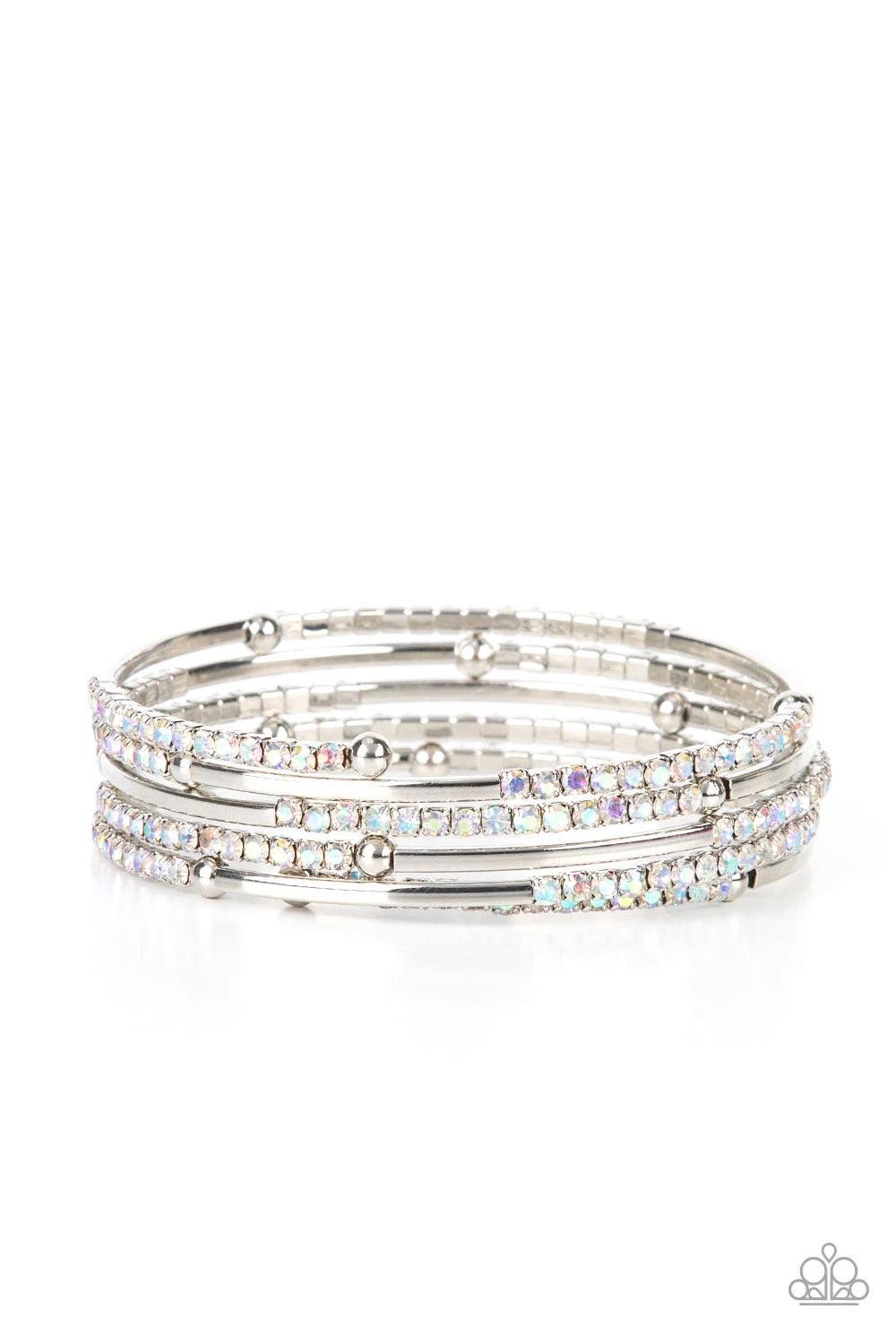 Paparazzi Accessories Camera Shy Simmer - Multi A dainty infinity style bracelet is infused with glittery rows of iridescent rhinestones and curving silver frames, creating simmering layers around the wrist. Sold as one individual bracelet. Jewelry