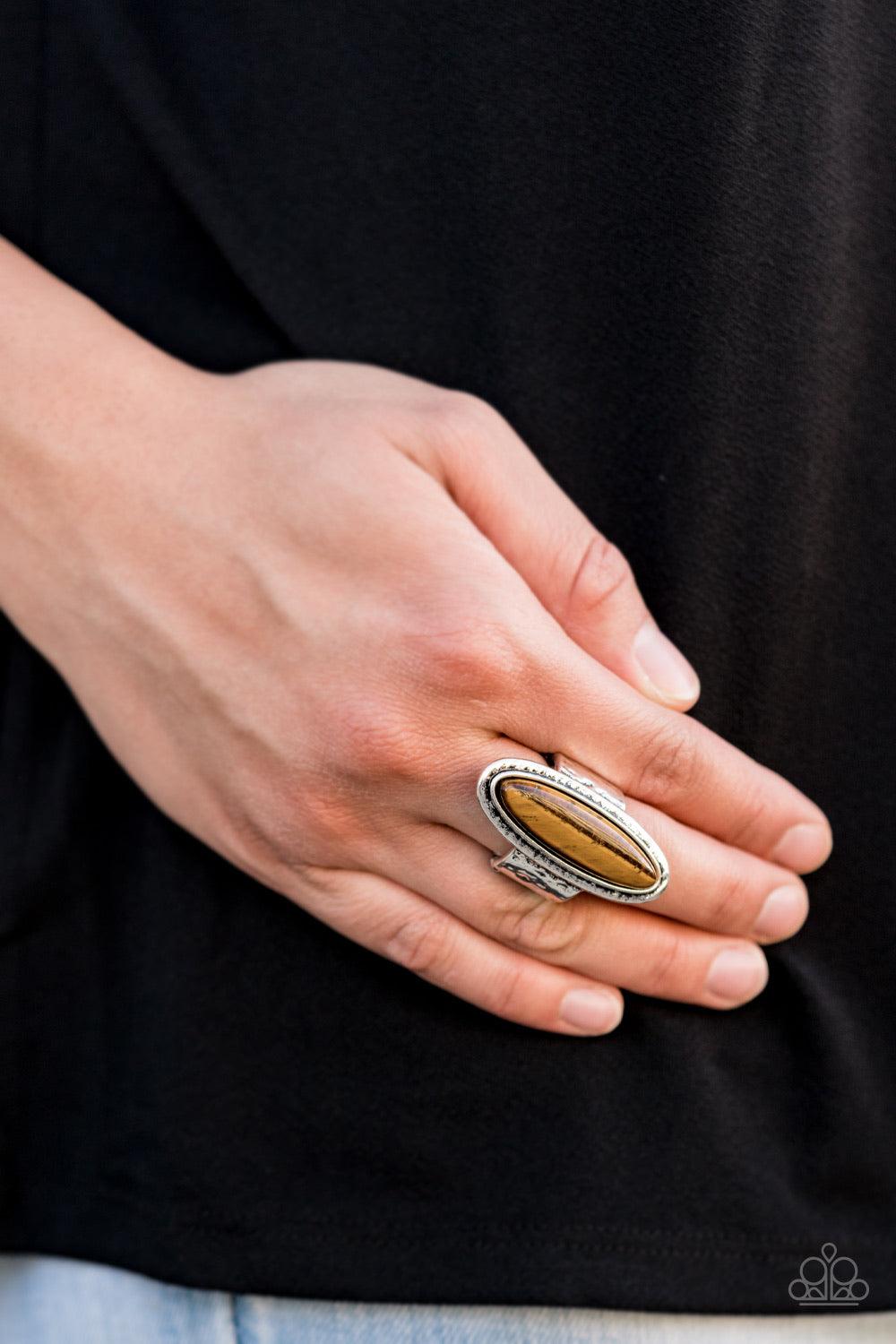 Paparazzi Accessories Stone Mystic - Brown An oblong Tiger’s Eye stone sits atop a hammered silver frame atop a hammered silver band, creating an earthy statement piece. Features a stretchy band for a flexible fit. Jewelry