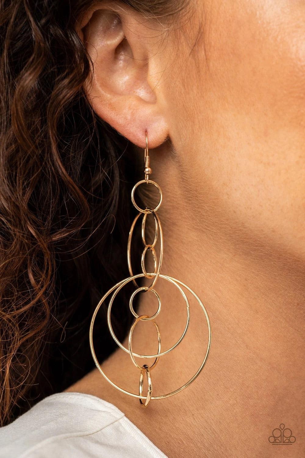 Paparazzi Accessories Running Circles Around You - Gold Small and medium sized gold links delicately alternate into an airy chain, while larger gold hoops haphazardly connect the chain into a dizzying lure. Earring attaches to a standard fishhook fitting.