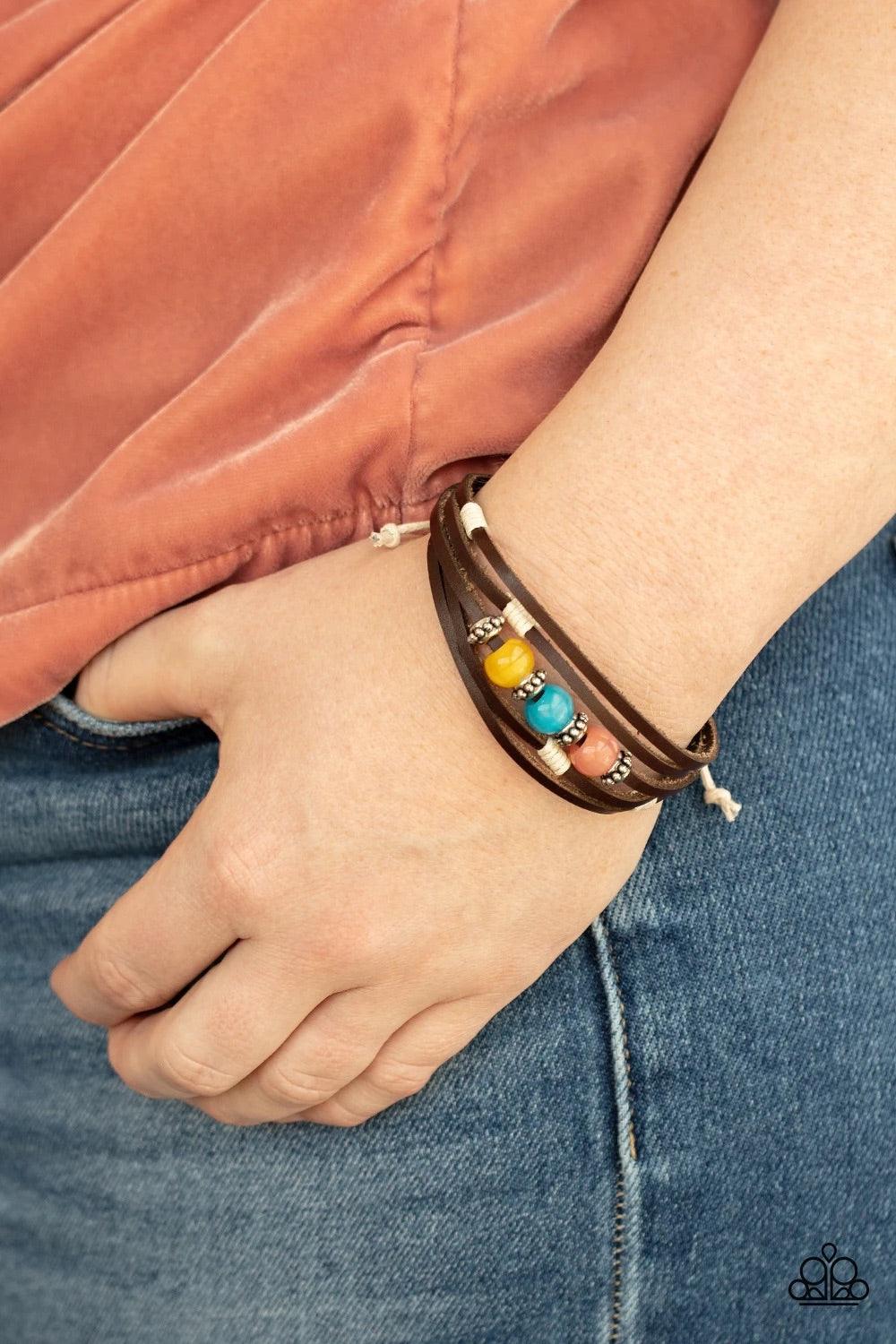 Paparazzi Accessories Homespun Radiance - Multi Infused with studded silver accents, a row of Desert Mist, Blue Tint, and Illuminating cat's eye stone beads adorn the centermost strand of layered leather bands around the wrist for a colorful seasonal look