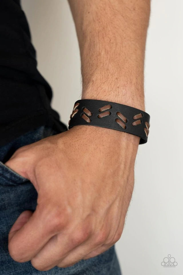 Paparazzi Accessories Suburban Wrangler - Black Brown leather laces are decoratively threaded through a black leather band, creating a rustic pattern around the wrist. Features an adjustable snap closure. Jewelry