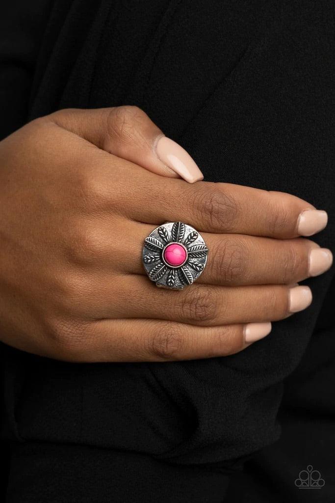 Paparazzi Accessories PALMS Reader - Pink An alternating collection of silver feathers and palm leaves fan out from a vivacious pink stone center atop a silver disc, creating a colorful display atop the finger. Features a stretchy band for a flexible fit.