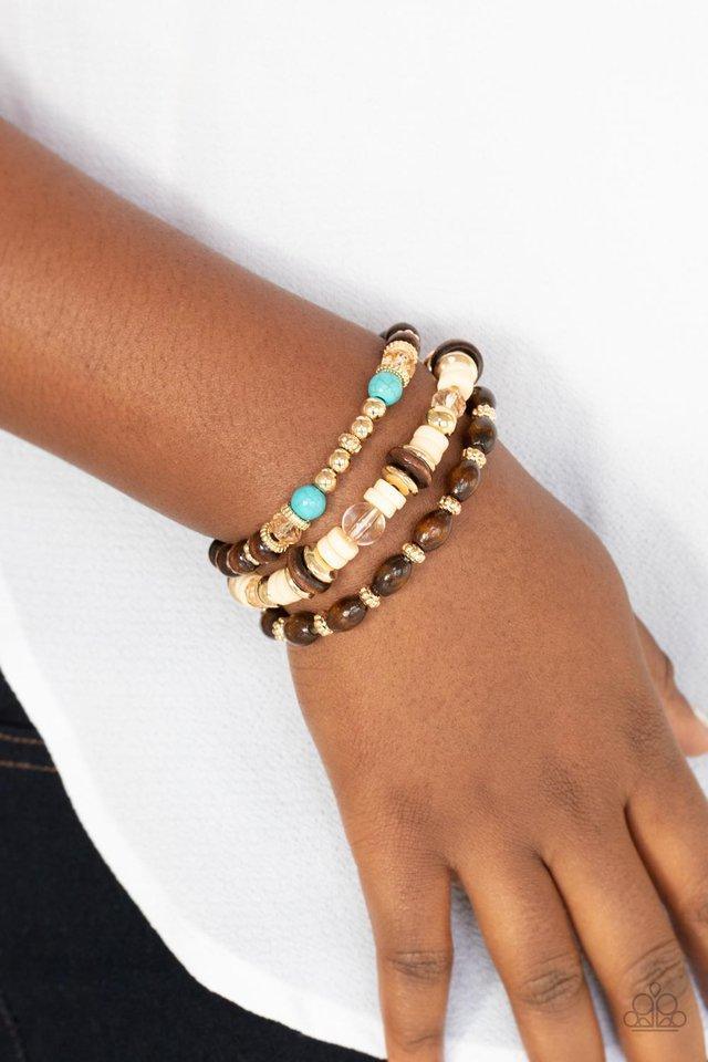 Paparazzi Accessories Belongs In The Wild - Yellow A mismatched collection of brown wooden beads, gold accents, turquoise stones, and glassy beads are threaded along stretchy bands, creating colorful layers around the wrist. An eclectic look that will be