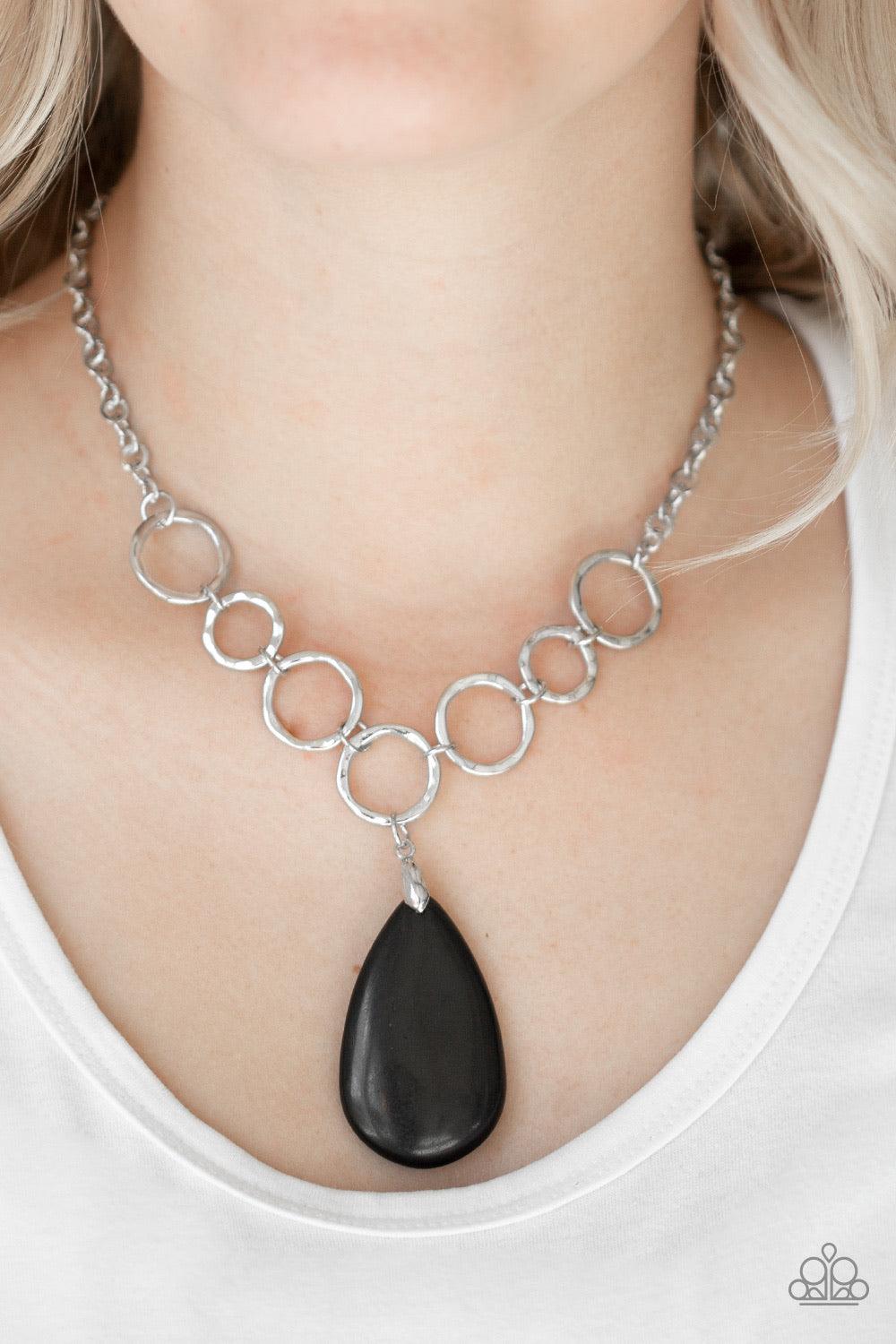 Paparazzi Accessories Livin On A Prairie - Black A collection of silver links give way to an earthy black stone teardrop, creating a tranquil pendant below the collar. Each silver ring is hammered in texture, adding an artisanal touch to the piece. Featur