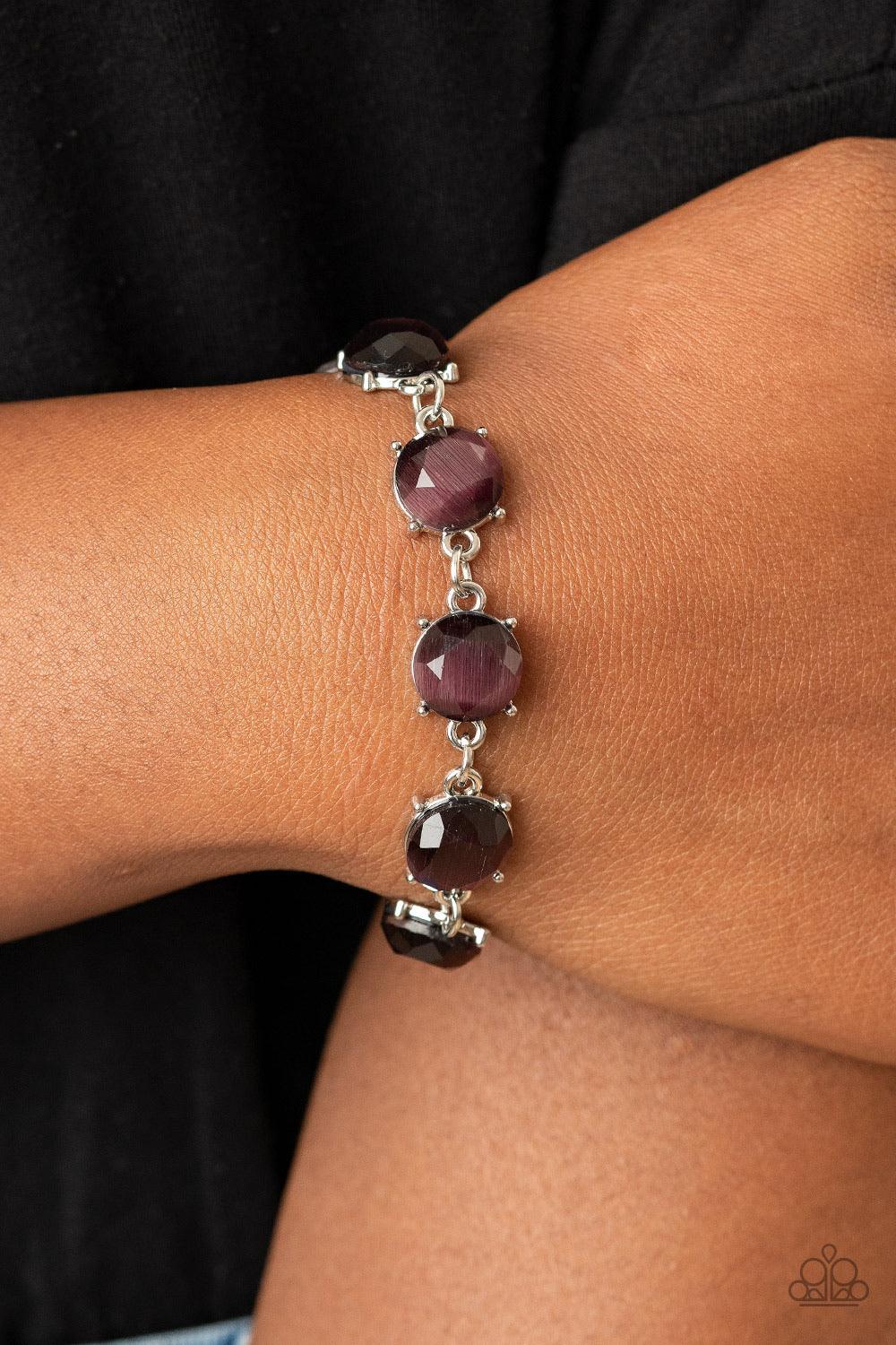 Paparazzi Accessories Ms. GLOW-It-All - Purple A glowing collection of faceted purple cat's eye stone frames delicately connect across the wrist for an ethereal look. Features an adjustable clasp closure. Sold as one individual bracelet. Jewelry