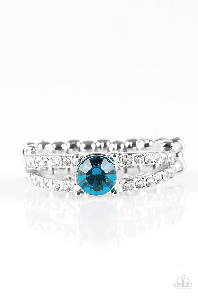 Paparazzi Accessories Dream Sparkle - Blue A glittery blue rhinestone sits atop two shimmery silver bands encrusted in glassy white rhinestones for a glamorous look. Features a dainty stretchy band for a flexible fit. Jewelry