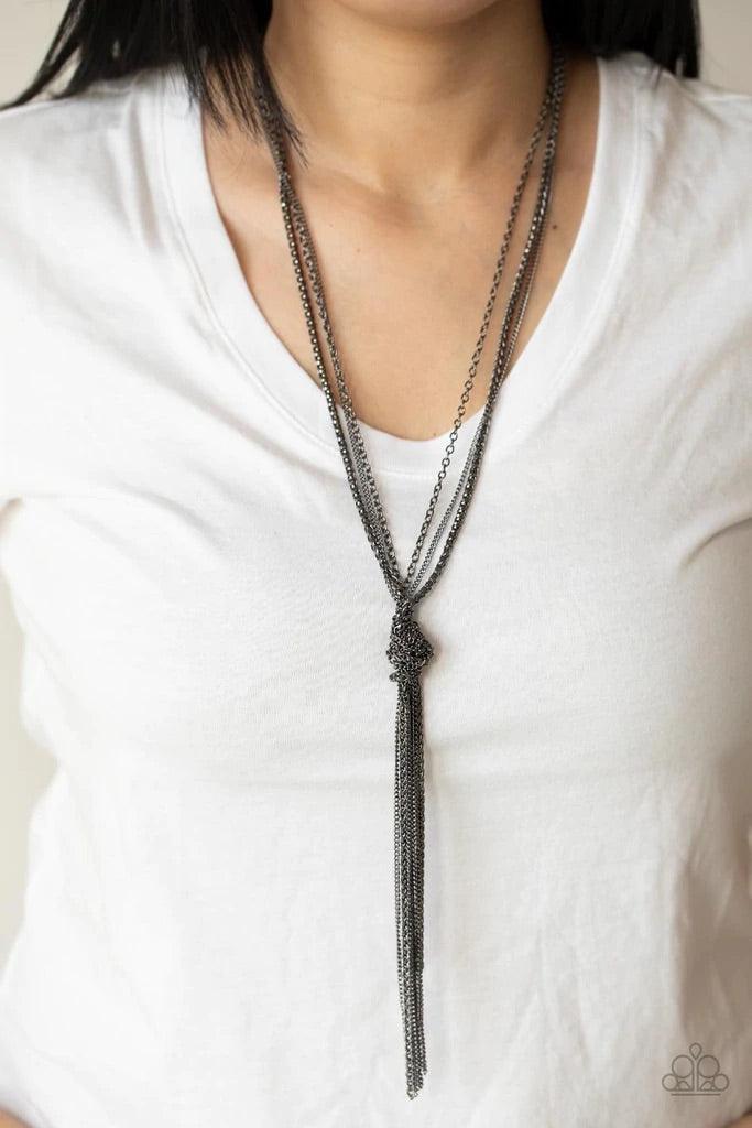 Paparazzi Accessories KNOT All There - Black Strands of long glistening gunmetal chains in round, delicate, and classic styles are pulled together in a sassy knot creating a show-stopping fringe pendant tassel and a flirty finish. Features an adjustable c