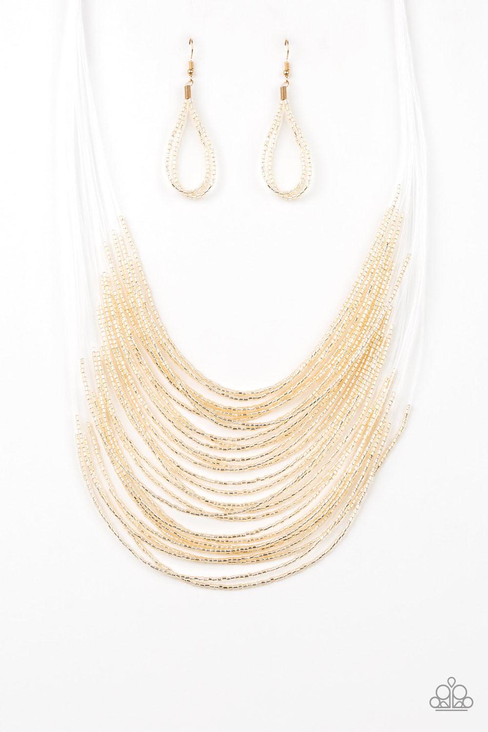 Paparazzi Accessories Catwalk Queen - Gold Strand after strand of metallic gold seed beads fall together to create a bold statement piece. Features an adjustable clasp closure. Sold as one individual necklace. Includes one pair of matching earrings. Jewel