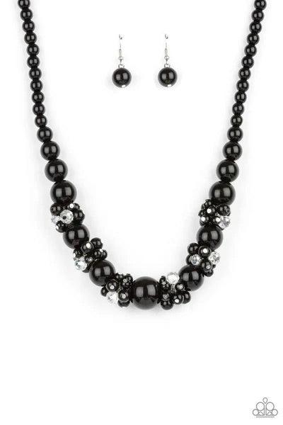 Paparazzi Accessories All Dolled UPSCALE - Black Dainty black beads and sparkly white crystal-like beads cluster between oversized black beads that are threaded along an invisible wire below the collar, creating a stunning centerpiece. Features an adjusta