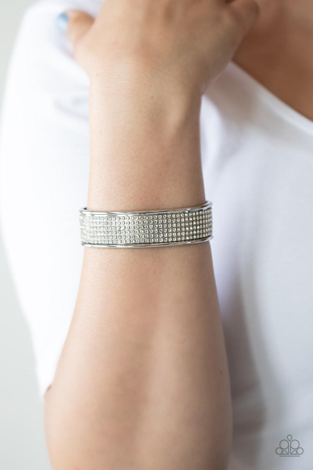 Paparazzi Accessories Can’t Believe Your ICE - White Row after row of white rhinestones are encrusted along the front of a thick silver cuff, creating a blinding statement piece around the wrist. Sold as one individual bracelet. This piece was featured as