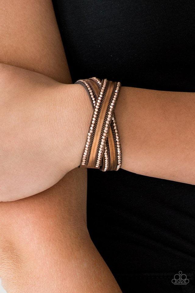 Paparazzi Accessories Rocker Rivalry - Copper Rows of classic copper chain, flat copper chain, and dainty metallic rhinestones are encrusted along a brown suede band dusted in golden sparkles for a sassy look. The elongated band allows for a trendy double