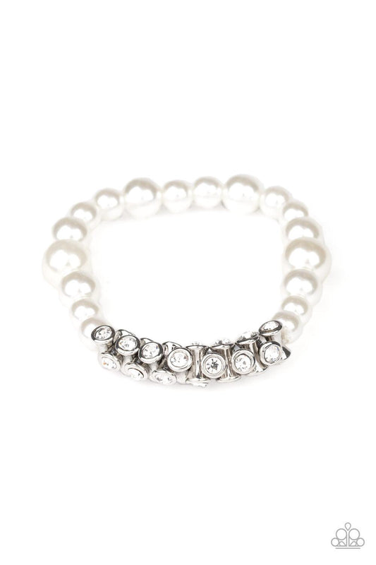 Paparazzi Accessories Traffic-Stopping Sparkle - White A collection of white pearls and white rhinestone dotted silver frames are threaded along stretchy bands around the wrist, creating a sparkling centerpiece. Sold as one individual bracelet. Jewelry