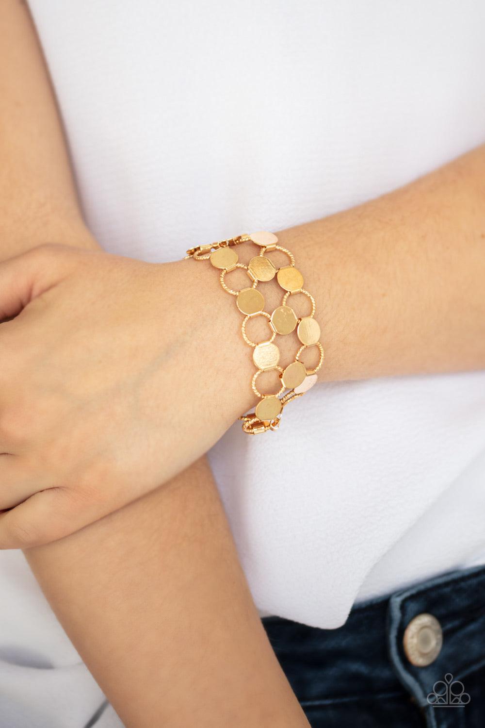 Paparazzi Accessories Cast A Wider Net - Gold Dotted with reflective gold discs, an interlocking net of textured gold rings link into edgy netted layers around the wrist. Features an adjustable clasp closure. Jewelry
