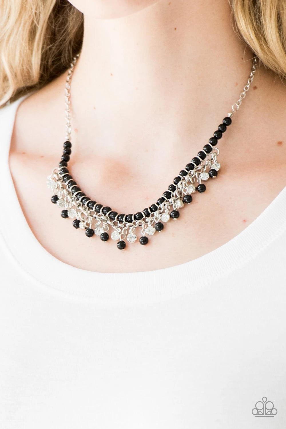 Paparazzi Accessories A Touch of CLASSY - Black Infused with silver chain, shiny black beads are threaded along an invisible wire below the collar. Matching black beads and glittery white rhinestones swing from the pearly strand, creating a flirtatious fr