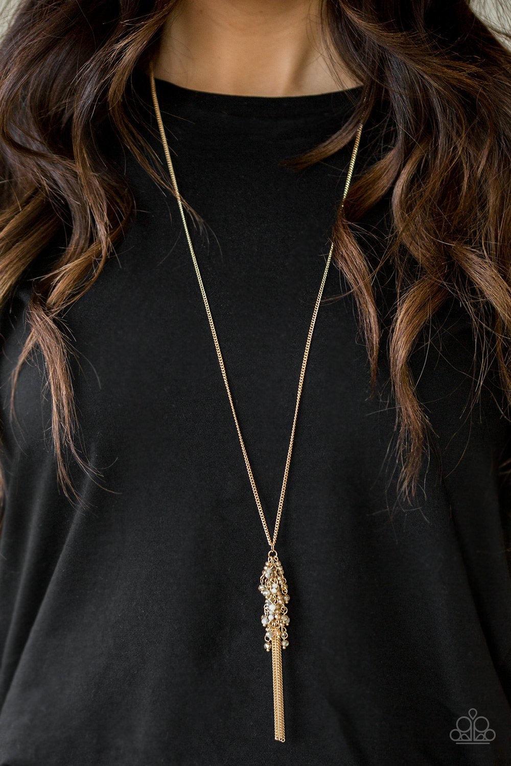Paparazzi Accessories Twilight Twinkle ~Multi Twinkling gold beads are threaded along dainty gold rods, creating a sparkling fringe at the bottom of a lengthened gold chain. A lobster clasp hangs from the bottom of the design to allow a name badge or othe