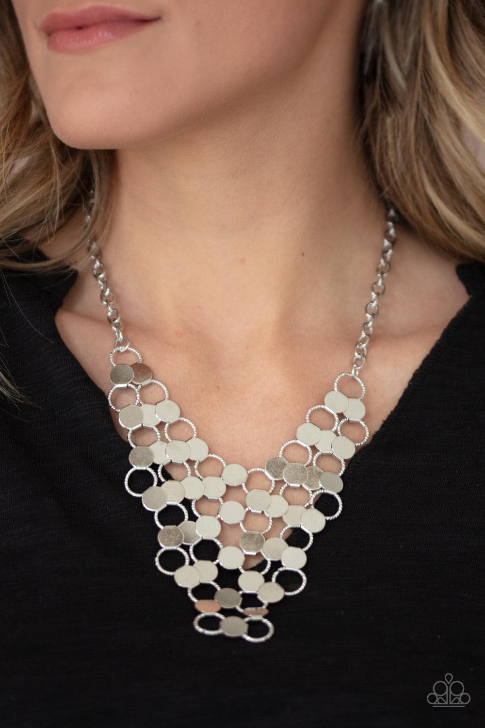 Paparazzi Accessories Net Result - Silver An interlocking net of textured silver rings and reflective silver discs link into a dramatically netted fringe below the collar. Features an adjustable clasp closure. Jewelry
