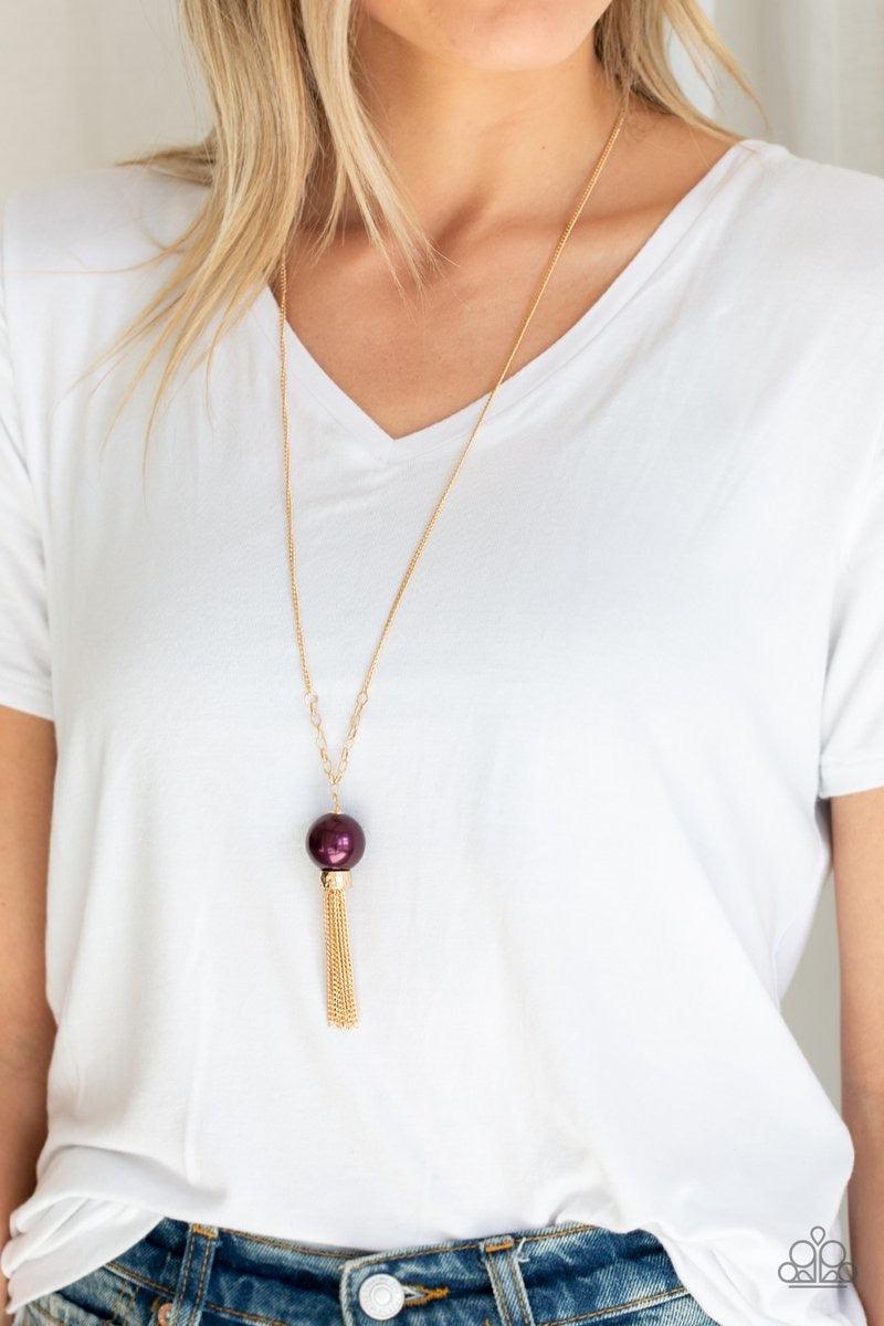 Paparazzi Accessories Belle of the BALLROOM - Purple A dramatic pearly purple bead swings from the bottom of an elegantly elongated gold chain. Featuring a hammered fitting, a gold tassel streams from the bottom of the colorful pendant for a refined finis
