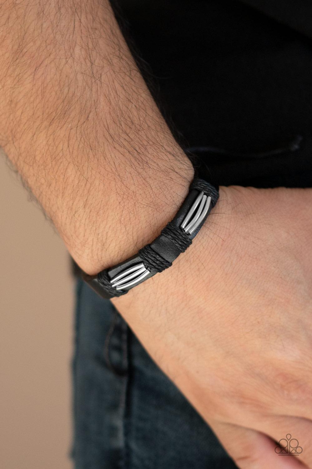 Paparazzi Accessories Industrial Interstate - Black Shiny silver accents are knotted in place across the front of a black leather band around the wrist for an edgy urban look. Features an adjustable sliding knot closure. Jewelry