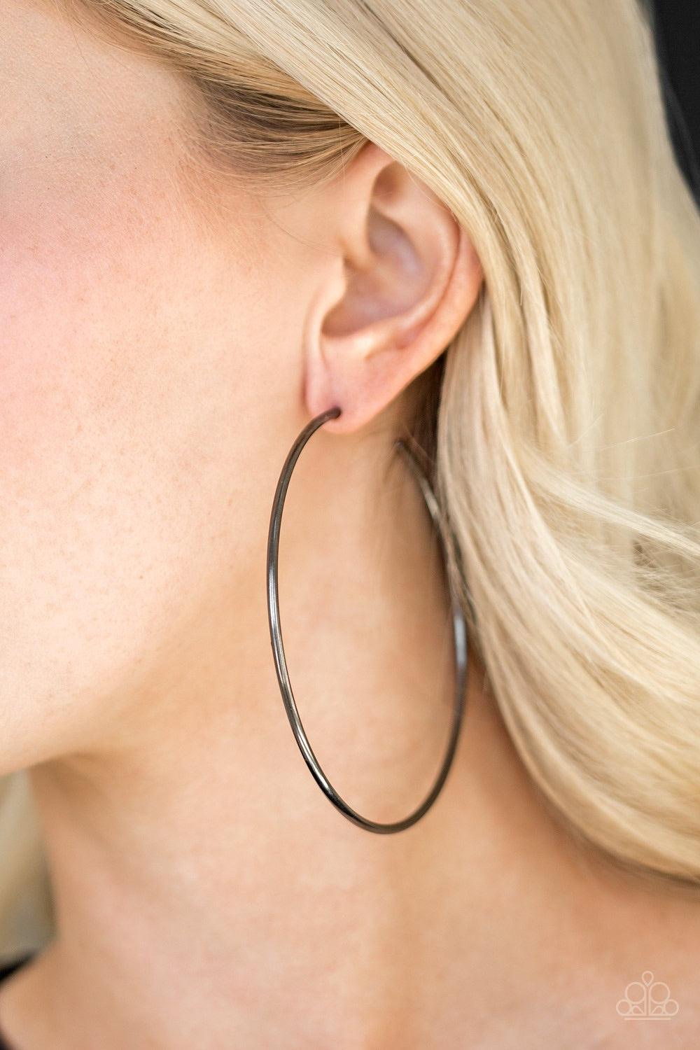 Paparazzi Accessories Meet Your Maker - Black A skinny ribbon of gunmetal curls into a bold hoop for a dramatic look. Earring attaches to a standard post fitting. Hoop measures 3” in diameter. Jewelry