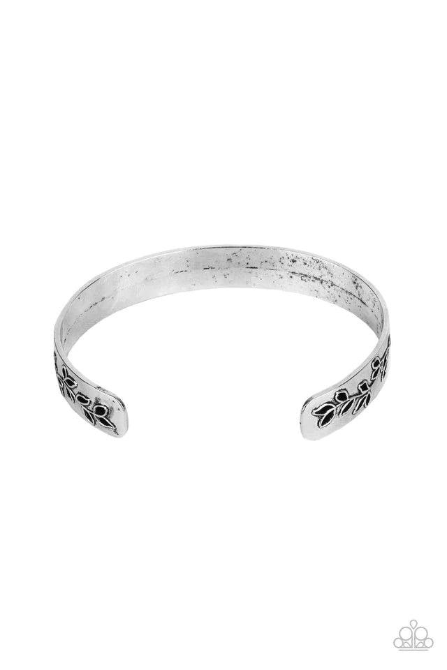 Paparazzi Accessories Fond Fable - Silver The ends of a dainty silver cuff are cutout and embossed in leafy filigree, creating a simple seasonal centerpiece around the wrist. Jewelry
