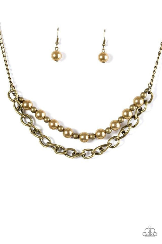 Paparazzi Accessories Glam and Grind - Brass Pearly brass and rustic brass beads are threaded along a skinny wire. The pearly beading gives way to a bold strand of brass chain, creating edgy layers below the collar. Features an adjustable clasp closure. S