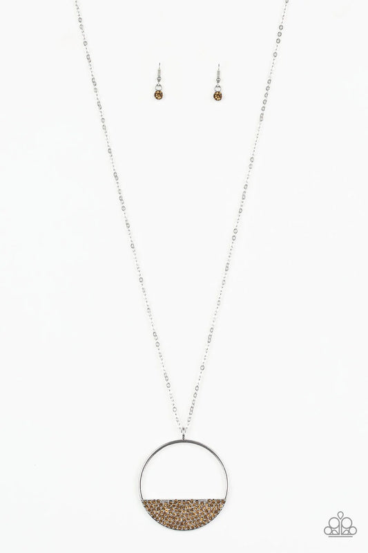 Paparazzi Accessories Bet Your Bottom Dollar - Brown Encrusted in golden topaz rhinestones, a silver crescent frame is pressed into the bottom of an airy circular pendant for a timeless look. Features an adjustable clasp closure. Sold as one individual ne