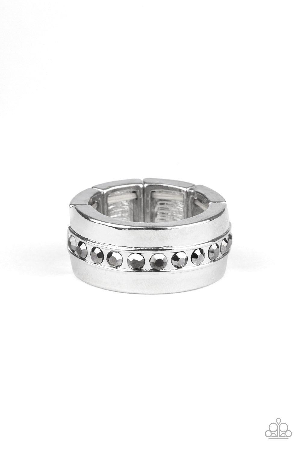 Paparazzi Accessories Reigning Champ - Silver A single row of glassy hematite rhinestones is encrusted along the center of a thick silver band. Features a stretchy band for a flexible fit. Jewelry