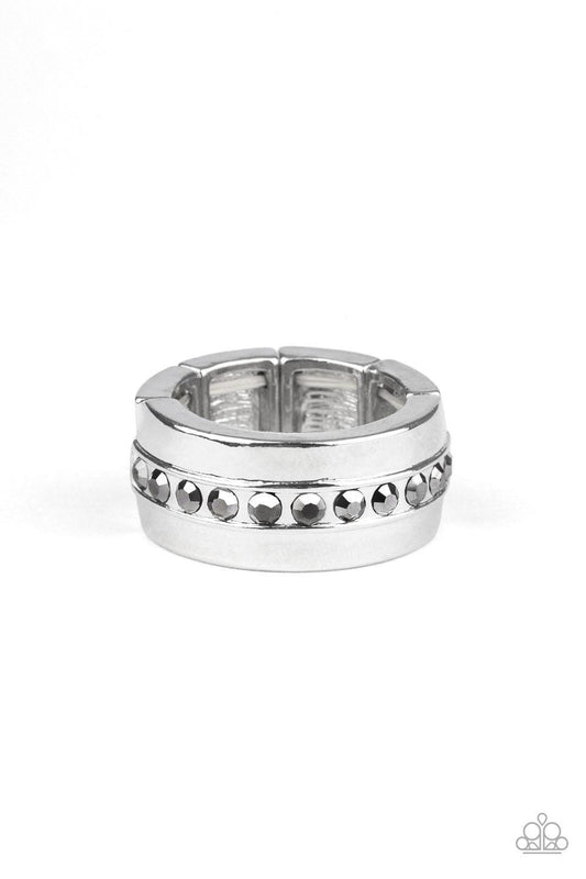 Paparazzi Accessories Reigning Champ - Silver A single row of glassy hematite rhinestones is encrusted along the center of a thick silver band. Features a stretchy band for a flexible fit. Jewelry