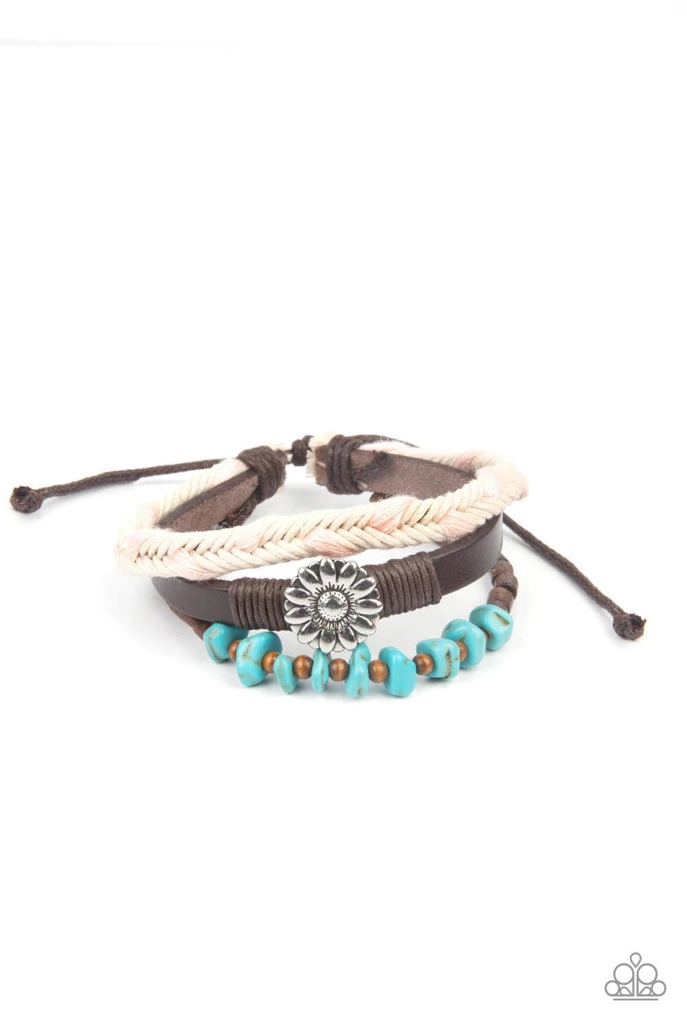 Paparazzi Accessories Terrain Trend - Pink Featuring a silver floral centerpiece, mismatched strands of turquoise stones and wooden beads, brown leather, and braided pink and white cording layers across the wrist for a seasonal flair. Features an adjustab