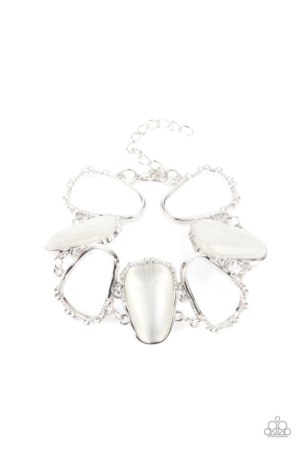 Paparazzi Accessories Yacht Club Couture - White Encased in studded silver frames, a tranquil collection of asymmetrical white cat’s eye stone teardrops and airy silver frames delicately link around the wrist for an ethereally sparkly display. A sprinklin