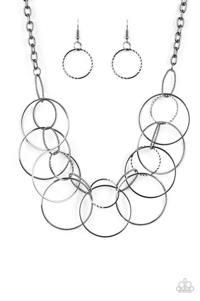 Paparazzi Accessories Circa De Couture - Black Textured gunmetal links connect to a collection of glistening gunmetal hoops below the collar, creating a statement-making fringe. Features an adjustable clasp closure. Sold as one individual necklace. Includ