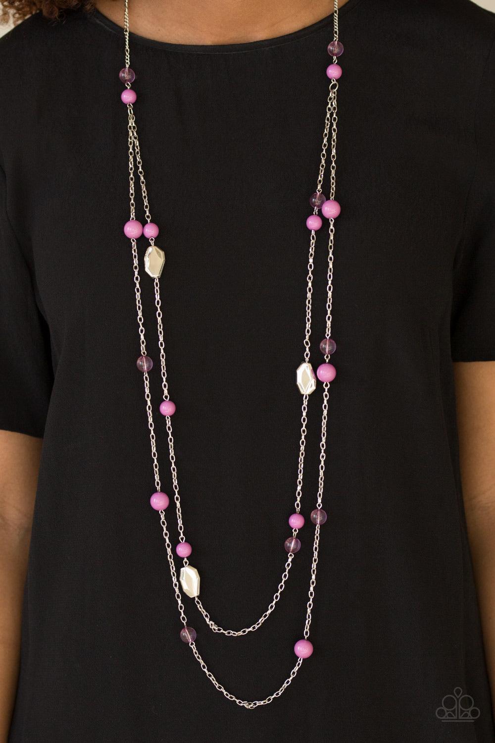 Paparazzi Accessories Hitting a Glow Point - Purple Featuring faceted silver accents, glassy and polished purple beads trickle along strands of shimmery silver chains for a seasonal look. Features an adjustable clasp closure. Jewelry