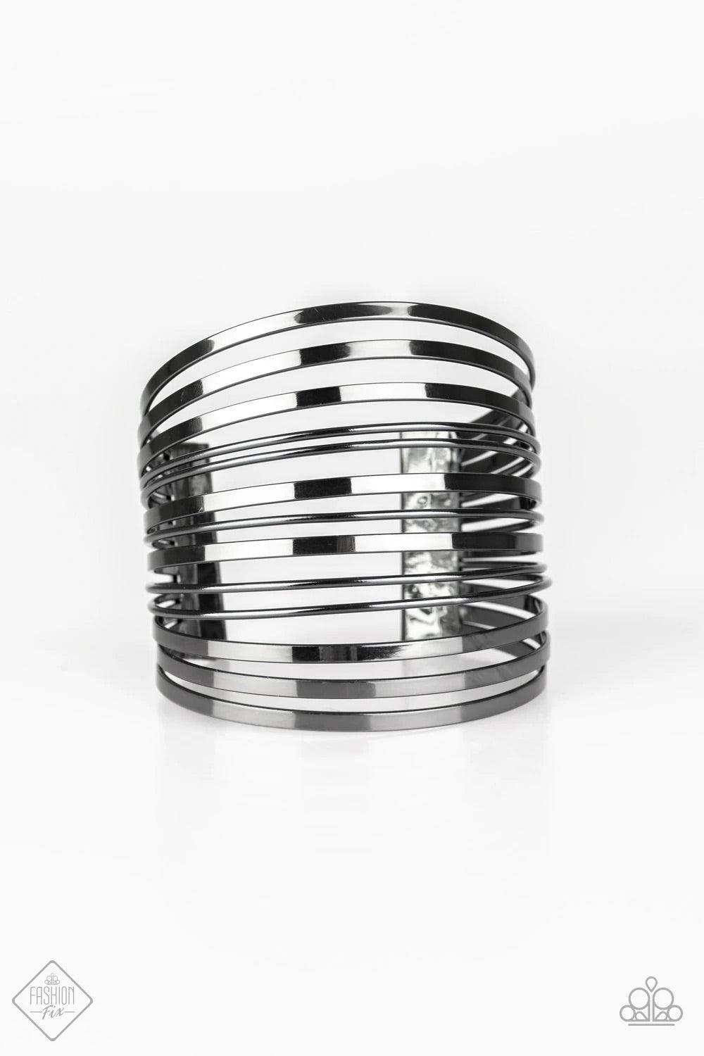 Paparazzi Accessories Front Line Shine ~Black Row after row of flat gunmetal and dainty gunmetal bars arc across the wrist, coalescing into a stacked cuff that demands attention. Sold as one individual bracelet.