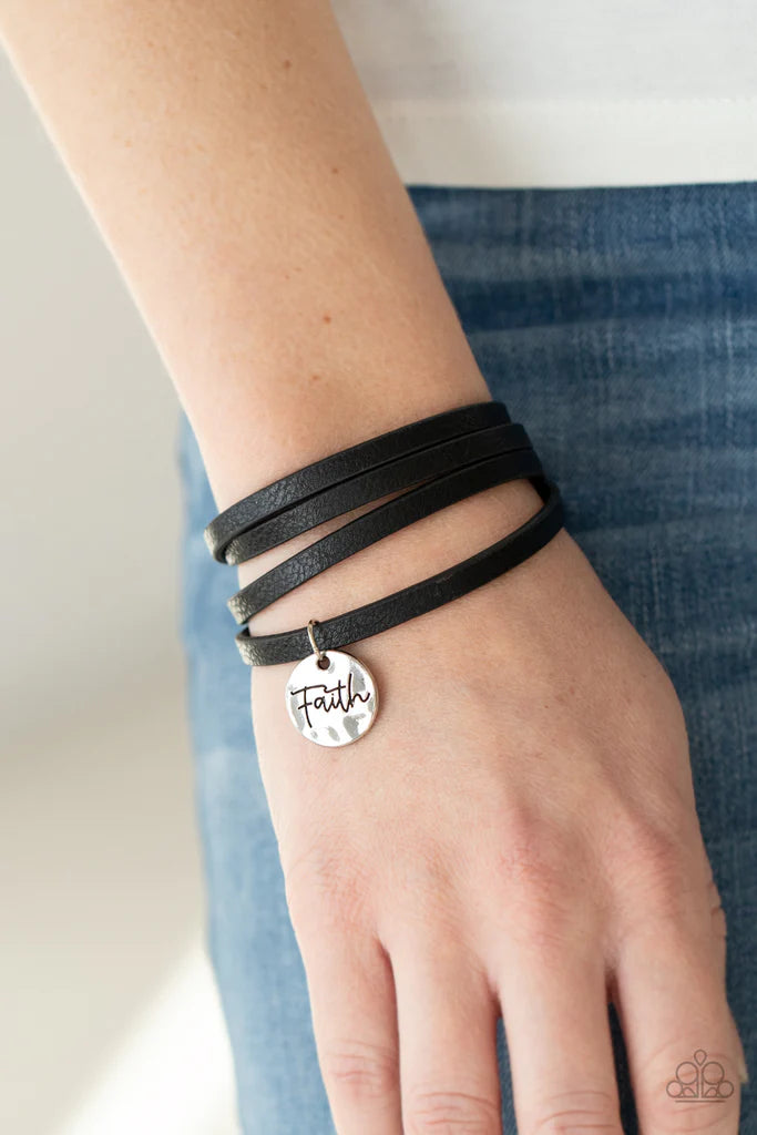 Paparazzi Accessories Wonderfully Worded - Black A hammered silver disc stamped in the word, "Faith" is threaded on a lengthened black leather cord that triple wraps around the wrist, creating a message of hope. Features an adjustable clasp closure. Sold