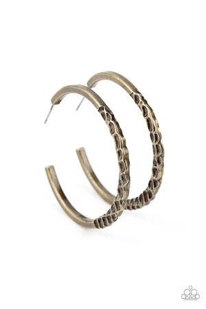 Paparazzi Accessories Imprinted Intensity - Brass The bottom of a dainty brass hoop has been dramatically hammered in gritty texture for an intense industrial finish. Earring attaches to a standard post fitting. Hoop measures approximately 1 3/4" in diame