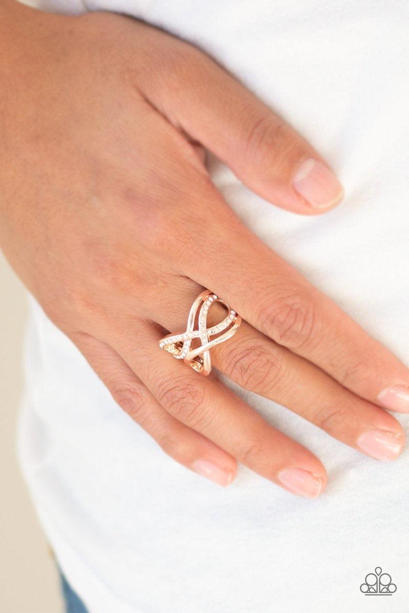 Paparazzi Accessories Infinite Illumination - Rose Gold Encrusted in sections of glittery white rhinestones, glistening rose gold infinities interweave into an airy band. Features a stretchy band for a flexible fit. Jewelry