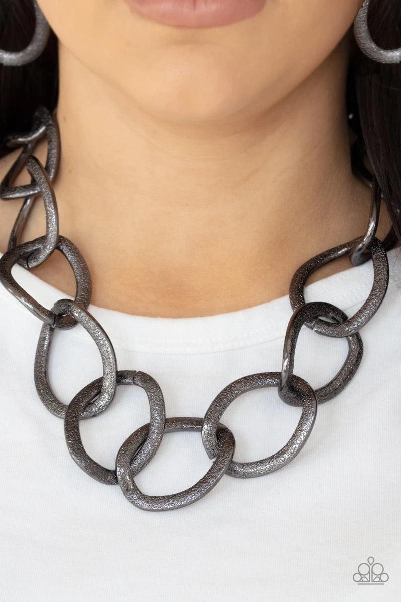 Paparazzi Accessories Industrial Intimidation - Black Surprisingly lightweight, enormous hematite links create an intimidating statement as they circle around the collar. The contoured, textured links have a distinctly industrial vibe that demands a secon