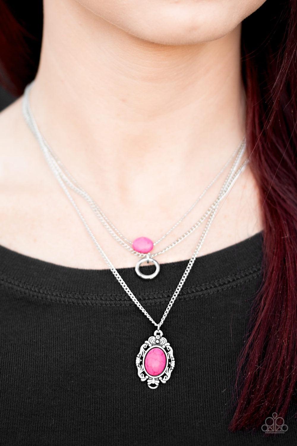 Paparazzi Accessories Canyon Cavalier - Pink A vivacious pink stone is suspended from the uppermost chain above a shimmery silver hoop and a pink stone pendant. Brushed in an antiqued shimmer, a regal silver frame encircles a pink stone, creating a whimsi