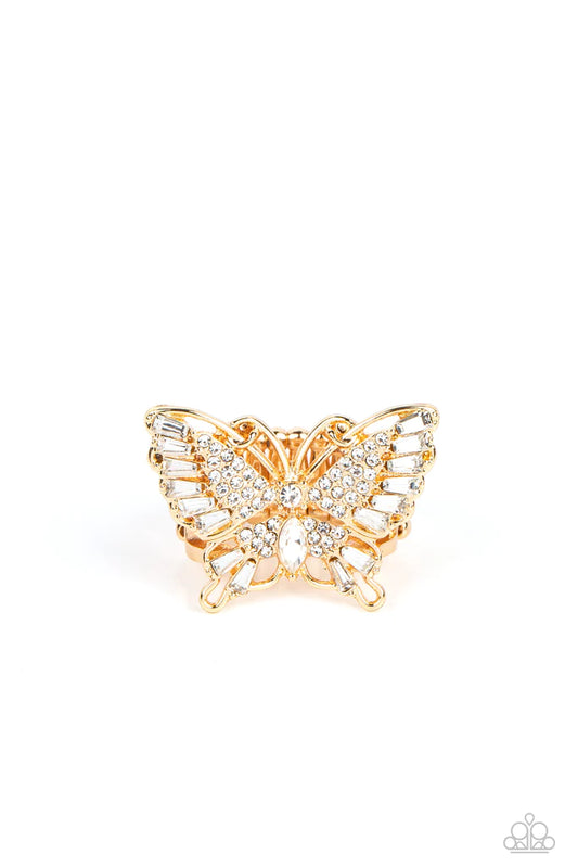 Paparazzi Accessories Fearless Flutter - Gold Sparkling with round, teardrop, and emerald cut white rhinestones, a gold butterfly fearlessly flutters atop the finger for a statement-making finish. Features a stretchy band for a flexible fit. Sold as one i