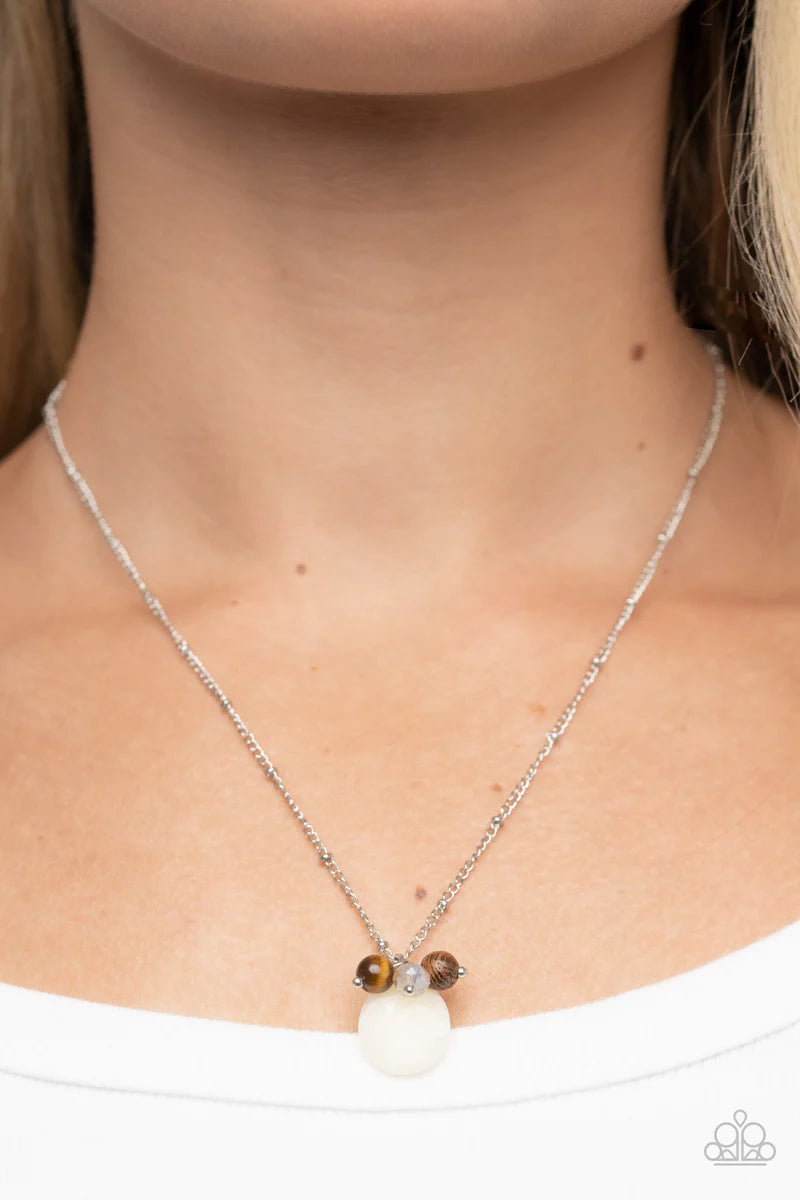 Paparazzi Accessories Cherokee Canyon - White An earthy cluster of wooden, crystal-like, and tiger's eye stone beads joins an enchanting quartz-like teardrop at the bottom of a dainty silver satellite chain, resulting in a tranquil pendant below the colla