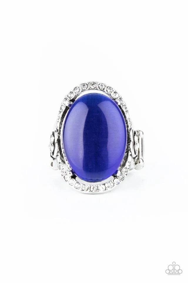 Paparazzi Accessories Happily Ever Enchanted - Blue An oval blue cat's eye stone is nestled inside a ring of white rhinestones featuring dainty heart details, creating a charming centerpiece atop the finger. Features a stretchy band for a flexible fit. Je