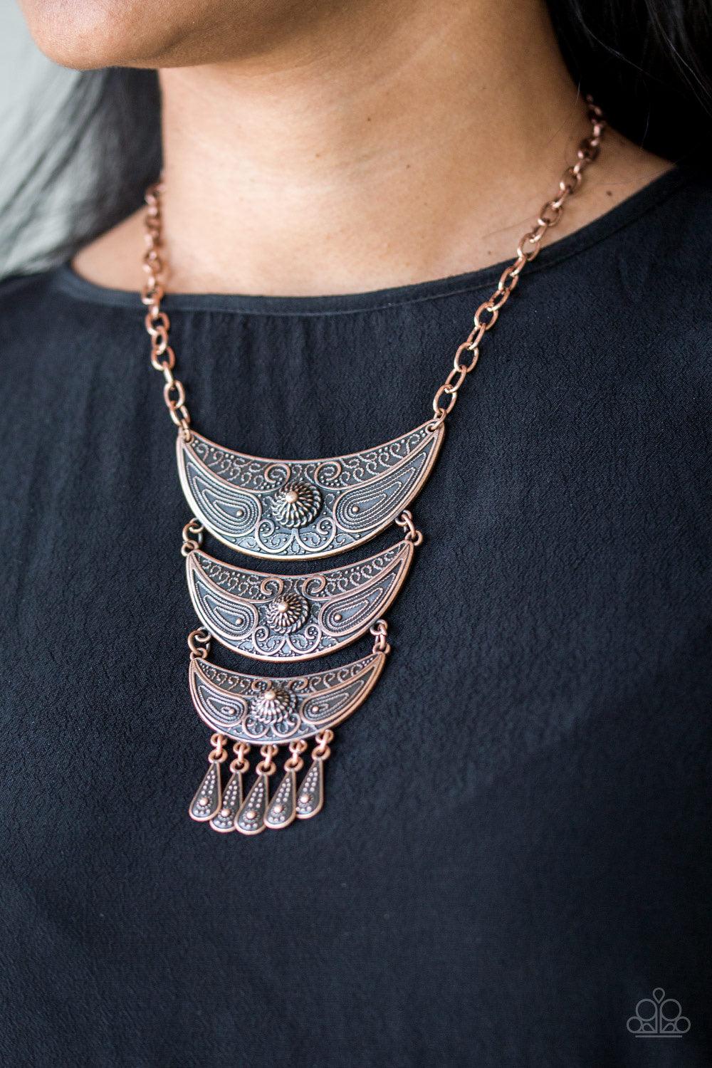 Paparazzi Accessories Go STEER -Crazy - Copper Gradually decreasing in size down the chest, decorative copper crescent plates connect into a bold pendant. Dotted in dainty studs, teardrop copper frames swing from the bottom of the tribal inspired pendant
