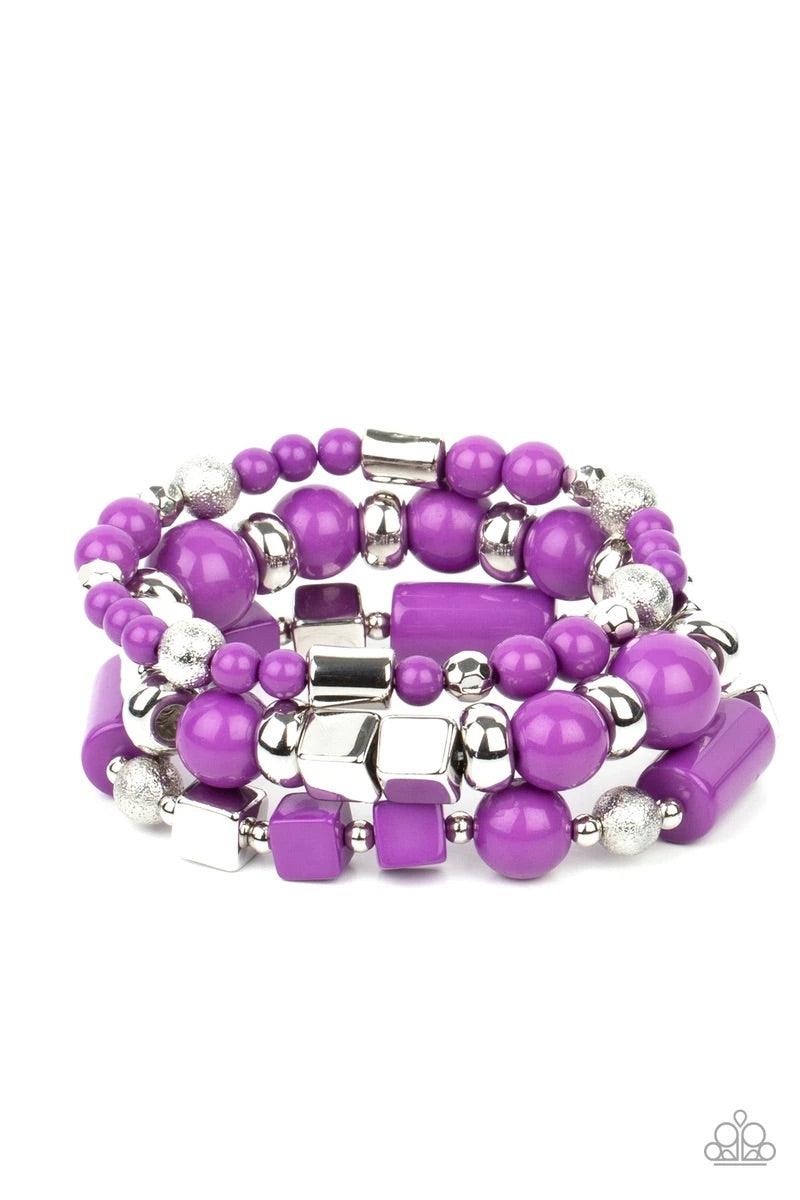 Paparazzi Accessories Perfectly Prismatic - Purple Featuring round, cube, and faceted shapes, a colorful collection of purple and silver beads are threaded along stretchy bands around the wrist, creating vivacious layers. Sold as one set of three bracelet